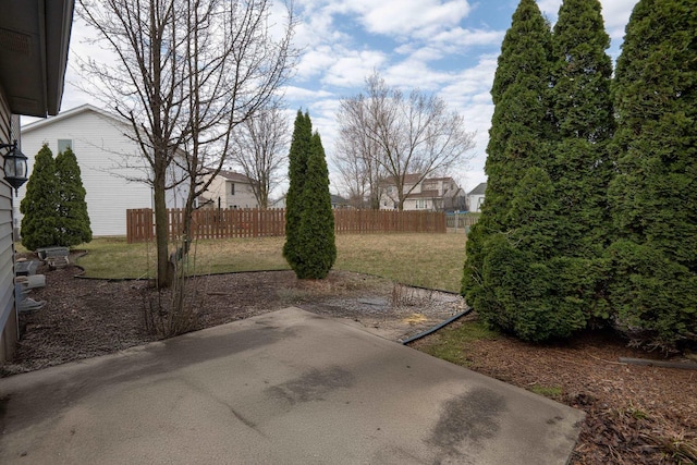 view of yard with fence and a patio