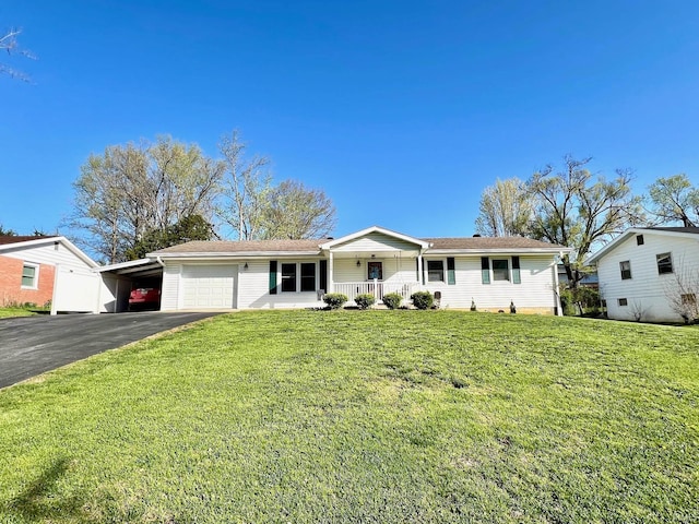 2119 Windwood Dr, Bedford, IN 47421 - ranch-style home with a carport, a front lawn, aphalt driveway, a garage, and covered porch