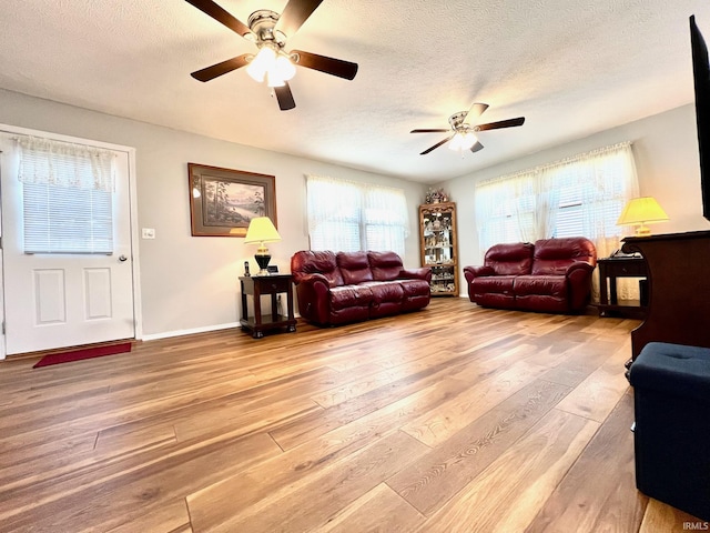 2119 Windwood Dr, Bedford, IN 47421 - living room with a textured ceiling, wood finished floors, baseboards, and a ceiling fan