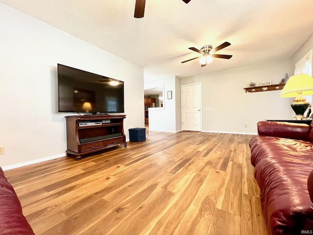 2119 Windwood Dr, Bedford, IN 47421 - living room featuring baseboards, a ceiling fan, and wood finished floors