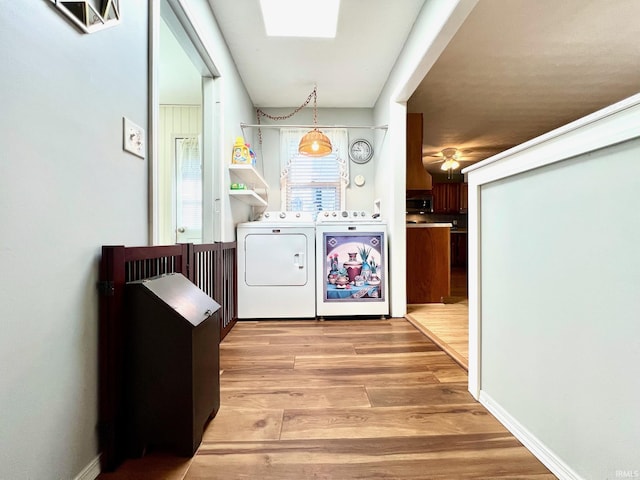 2119 Windwood Dr, Bedford, IN 47421 - washroom with light wood finished floors, laundry area, washing machine and clothes dryer, and a ceiling fan