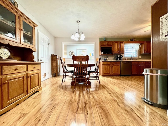 2119 Windwood Dr, Bedford, IN 47421 - dining area with light wood-style floors and an inviting chandelier