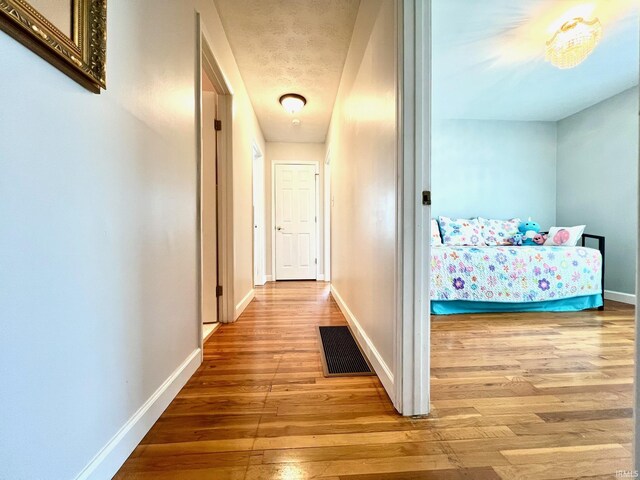 2119 Windwood Dr, Bedford, IN 47421 - hall featuring visible vents, baseboards, and hardwood / wood-style floors