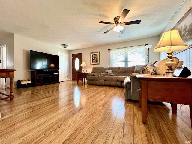 2119 Windwood Dr, Bedford, IN 47421 - living area featuring light wood-style flooring, a textured ceiling, and ceiling fan