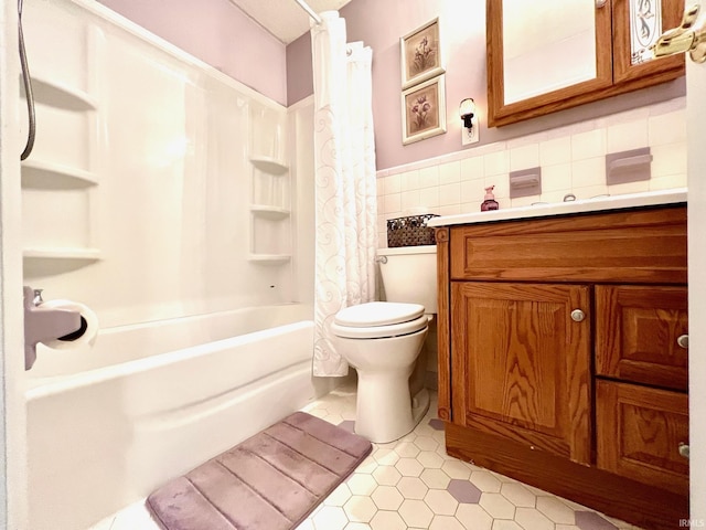2119 Windwood Dr, Bedford, IN 47421 - full bathroom with vanity, tile patterned floors, shower / bath combination with curtain, toilet, and tile walls