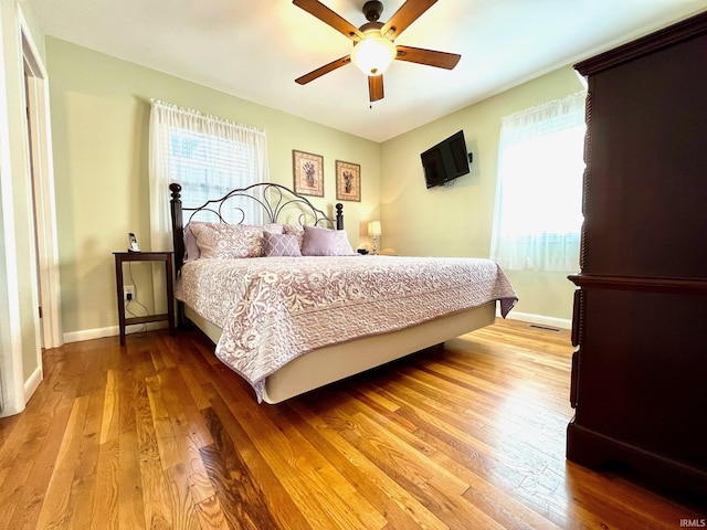 2119 Windwood Dr, Bedford, IN 47421 - bedroom with visible vents, baseboards, a ceiling fan, and wood finished floors