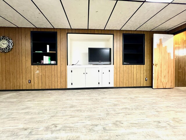 2119 Windwood Dr, Bedford, IN 47421 - unfurnished living room with wood finished floors, wood walls, and built in shelves