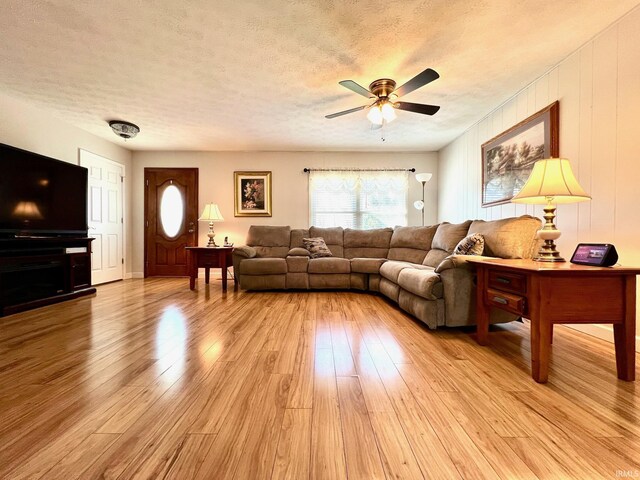 2119 Windwood Dr, Bedford, IN 47421 - living area with a ceiling fan, light wood-style floors, and a textured ceiling