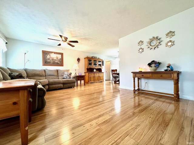 2119 Windwood Dr, Bedford, IN 47421 - living area featuring light wood-style flooring, a ceiling fan, and baseboards