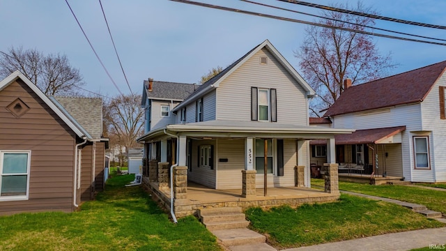country-style home with covered porch and a front lawn