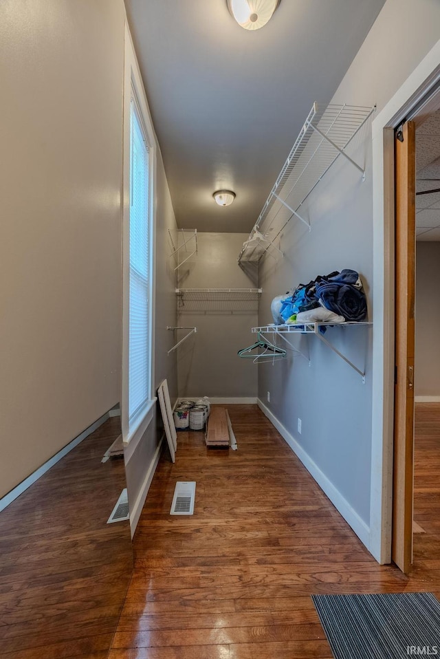 walk in closet featuring visible vents and wood finished floors