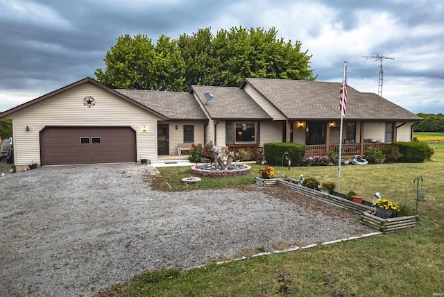single story home featuring a porch, a front lawn, an attached garage, a shingled roof, and driveway