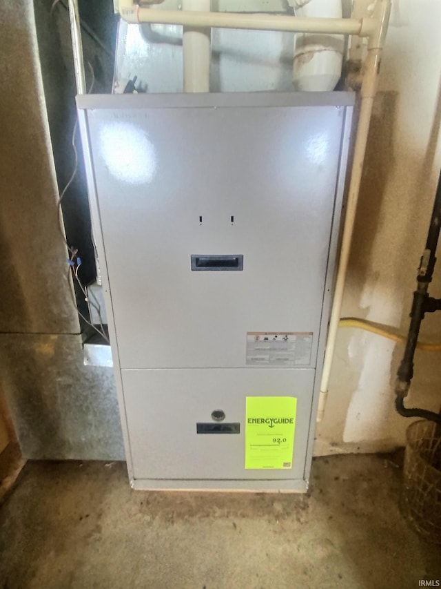 utility room featuring heating unit