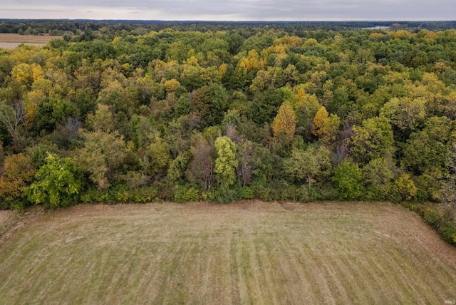 birds eye view of property with a view of trees
