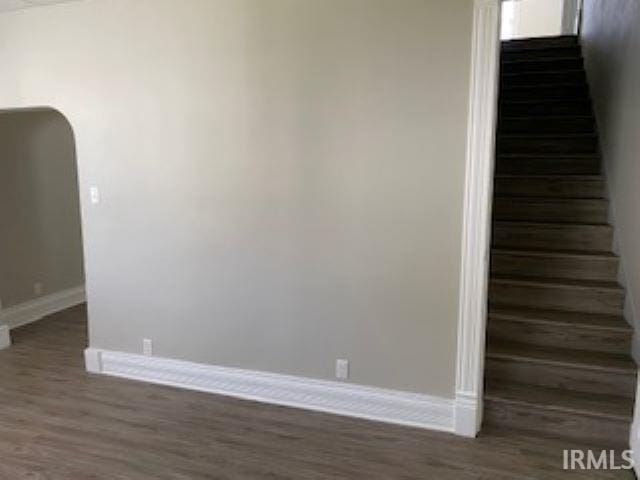 stairway with wood finished floors and baseboards