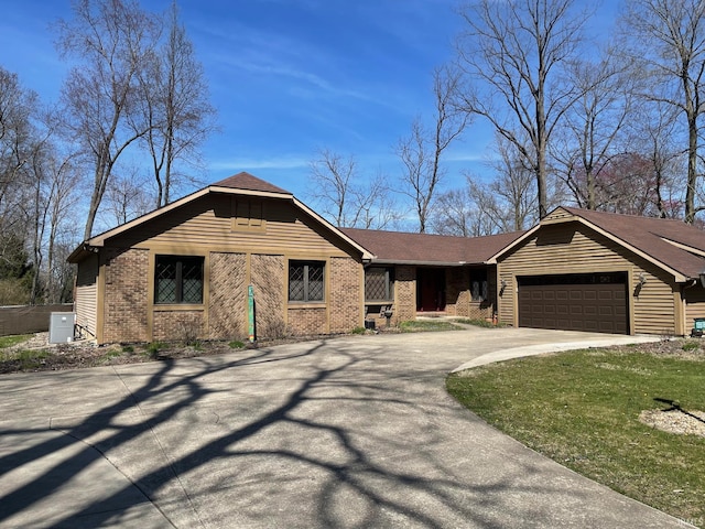 15516 Menominee Dr, Plymouth, IN 46563 - ranch-style home with a garage, aphalt driveway, and brick siding
