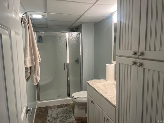 15516 Menominee Dr, Plymouth, IN 46563 - bathroom featuring a shower stall, vanity, a drop ceiling, toilet, and tile patterned floors