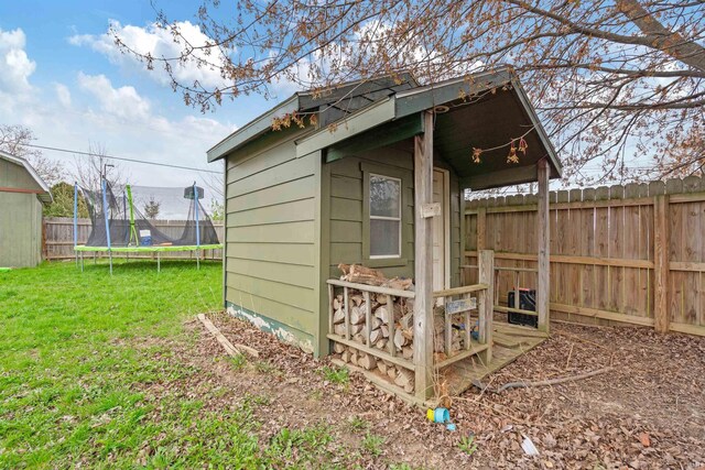 1918 Elva Dr, Kokomo, IN 46901 - view of outdoor structure featuring a trampoline, a fenced backyard, and an outdoor structure