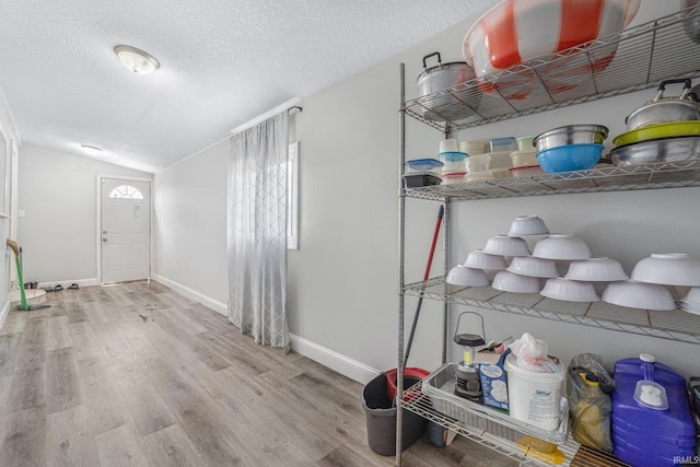 3930 Abbott St, Fort Wayne, IN 46806 - entrance foyer with lofted ceiling, a textured ceiling, baseboards, and wood finished floors
