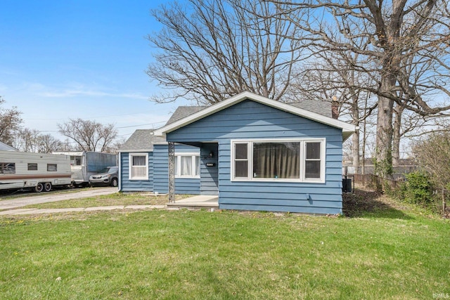 3930 Abbott St, Fort Wayne, IN 46806 - bungalow-style house with a front lawn, a shingled roof, and a chimney