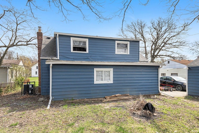 3930 Abbott St, Fort Wayne, IN 46806 - rear view of house featuring roof with shingles, a chimney, and fence