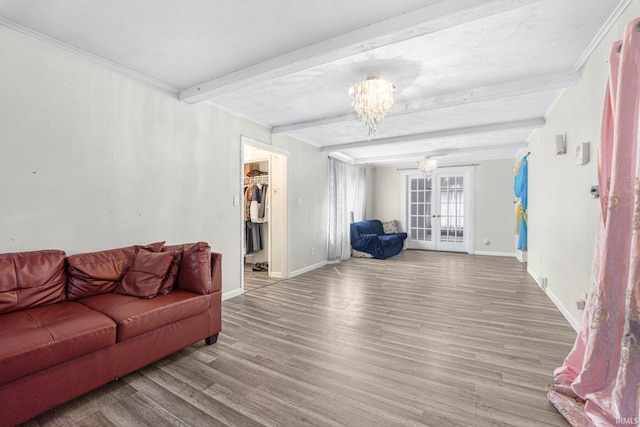 3930 Abbott St, Fort Wayne, IN 46806 - living room featuring baseboards, an inviting chandelier, beamed ceiling, wood finished floors, and french doors