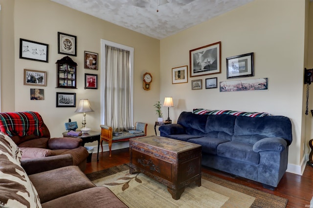 living area with baseboards and wood finished floors