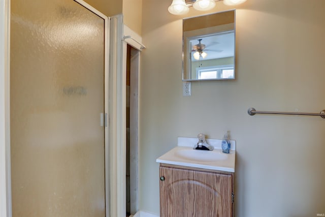 full bath featuring a shower stall, ceiling fan, and vanity