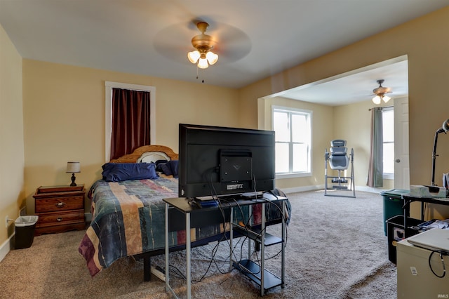 carpeted bedroom with baseboards and ceiling fan