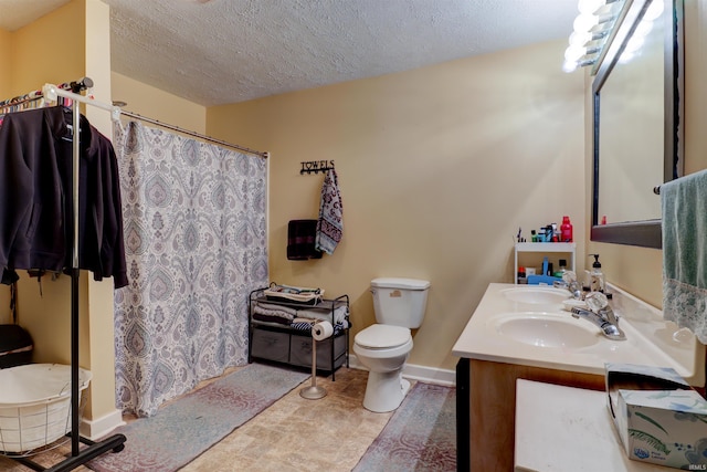 full bath with baseboards, a textured ceiling, a sink, and toilet