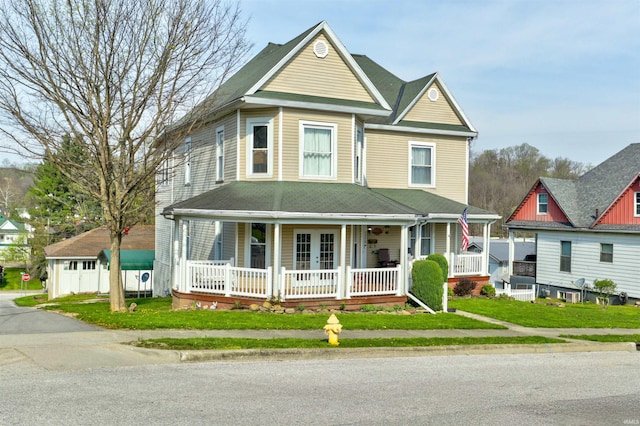 victorian house with a front lawn and covered porch