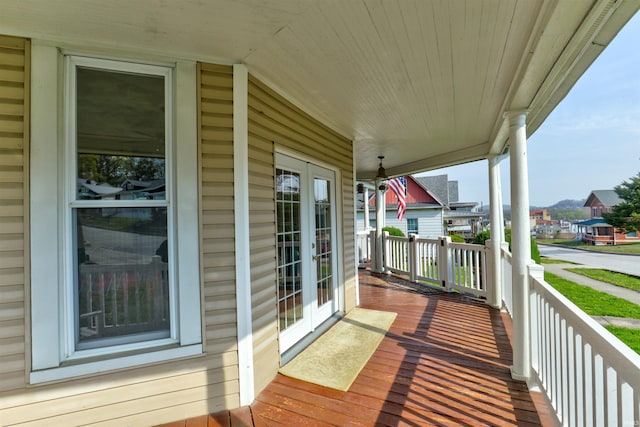 wooden terrace featuring french doors and a residential view