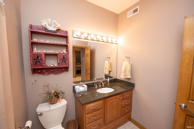 bathroom with visible vents, toilet, vanity, and tile patterned floors