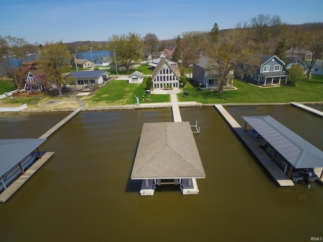 birds eye view of property with a residential view and a water view