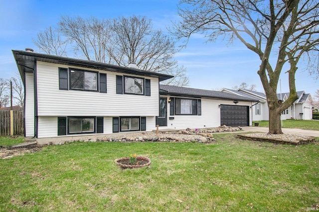 214 Parkwood Ln, South Bend, IN 46619 - tri-level home featuring a garage, concrete driveway, and a front lawn