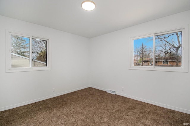 214 Parkwood Ln, South Bend, IN 46619 - unfurnished room with visible vents, baseboards, and dark carpet