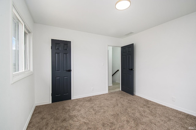 214 Parkwood Ln, South Bend, IN 46619 - unfurnished bedroom featuring visible vents, baseboards, and carpet