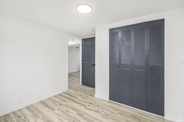 214 Parkwood Ln, South Bend, IN 46619 - unfurnished bedroom featuring a closet, baseboards, and wood finished floors