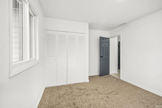 214 Parkwood Ln, South Bend, IN 46619 - unfurnished bedroom with visible vents, baseboards, a closet, and carpet