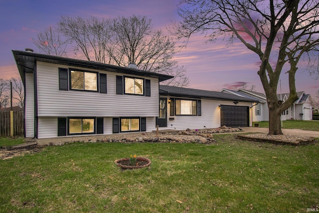 214 Parkwood Ln, South Bend, IN 46619 - split level home with a front yard, an attached garage, and concrete driveway
