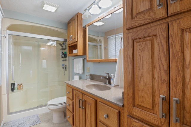 full bath featuring a shower stall, toilet, and vanity