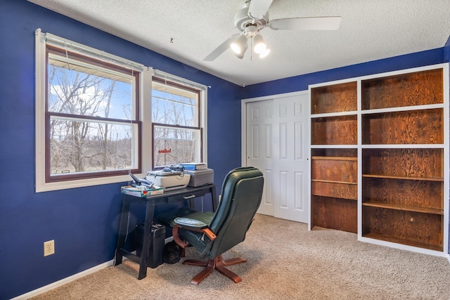 carpeted office with baseboards, a textured ceiling, and ceiling fan