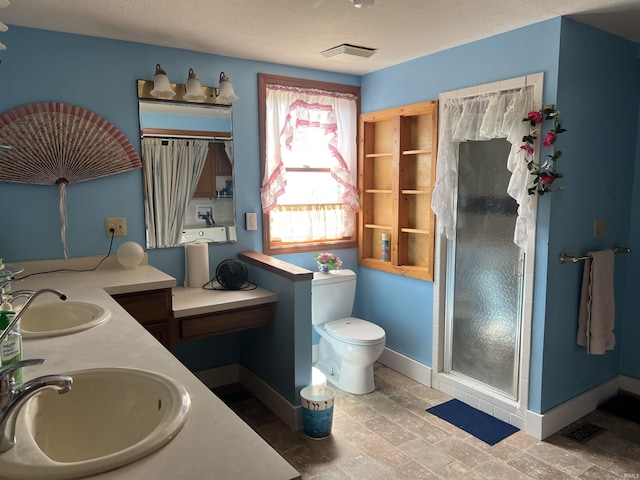 full bathroom with a shower stall, baseboards, a sink, and visible vents