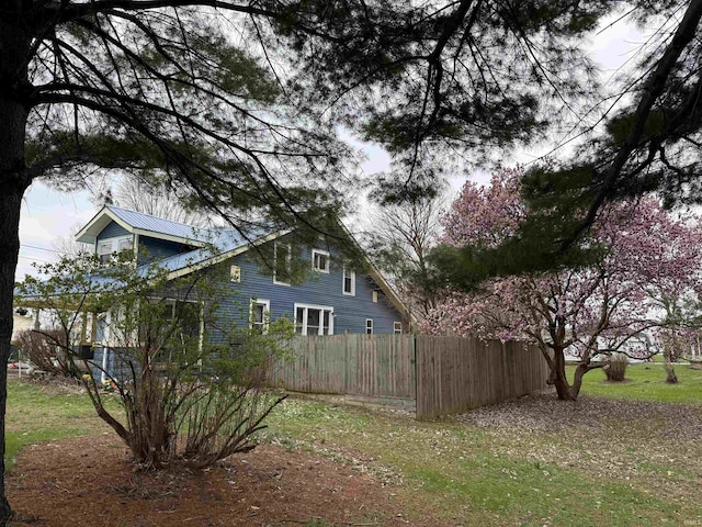 view of home's exterior featuring fence