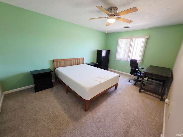 bedroom with visible vents, baseboards, a textured ceiling, carpet flooring, and ceiling fan