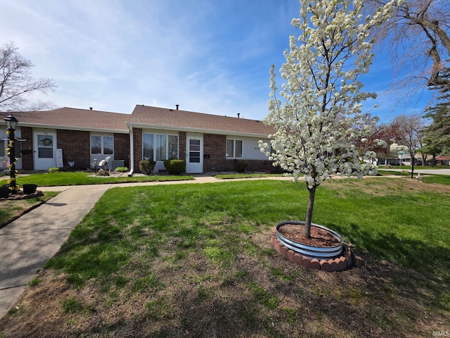 ranch-style house with brick siding and a front lawn