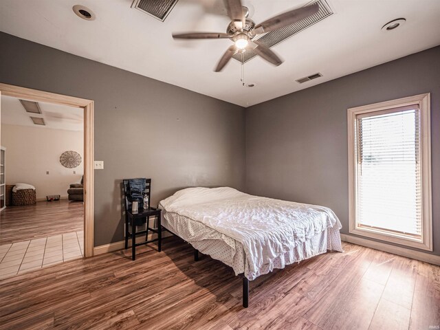 8901 Vienna Rd, Evansville, IN 47720 - bedroom with ceiling fan, baseboards, wood finished floors, and visible vents
