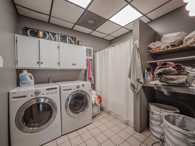 8901 Vienna Rd, Evansville, IN 47720 - washroom featuring separate washer and dryer, cabinet space, and light tile patterned flooring