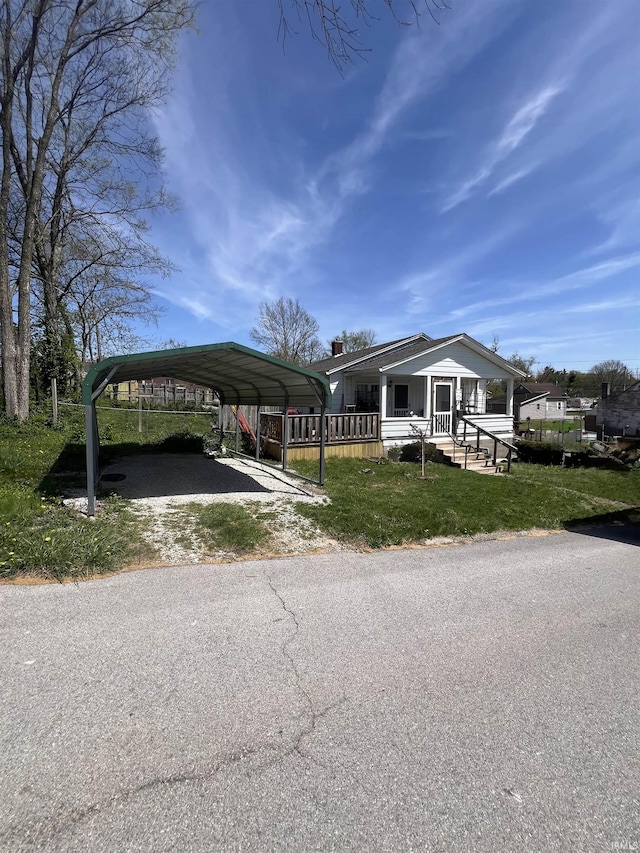 110 SW 3rd St, Paoli, IN 47454 - manufactured / mobile home featuring driveway, a carport, and a front yard