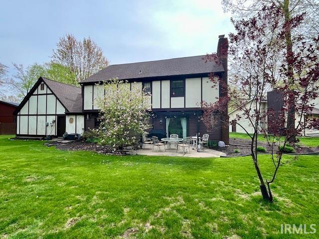6827 Belle Plain Cv, Fort Wayne, IN 46835 - rear view of house featuring a lawn, a chimney, and a patio area